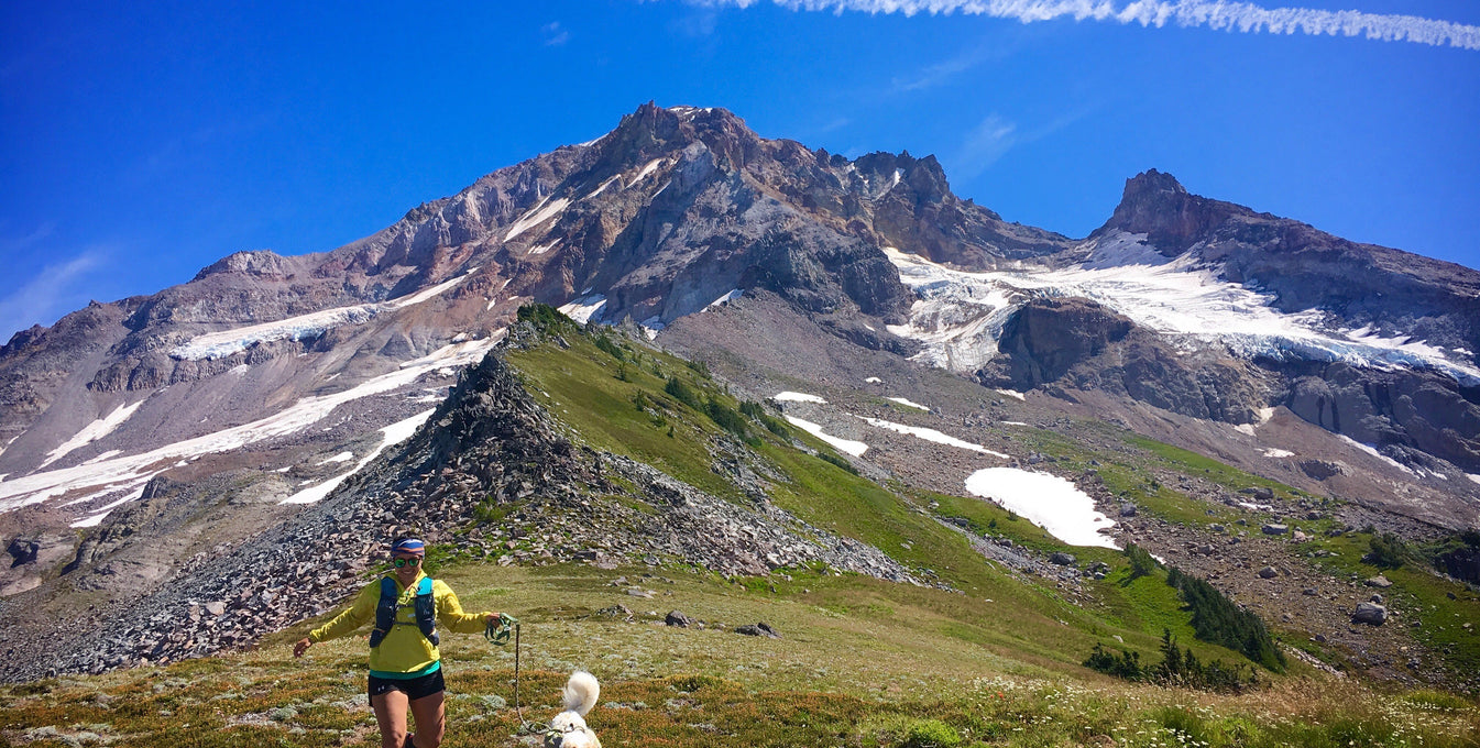 Theresa runs with her dog Cassie through the mountains.